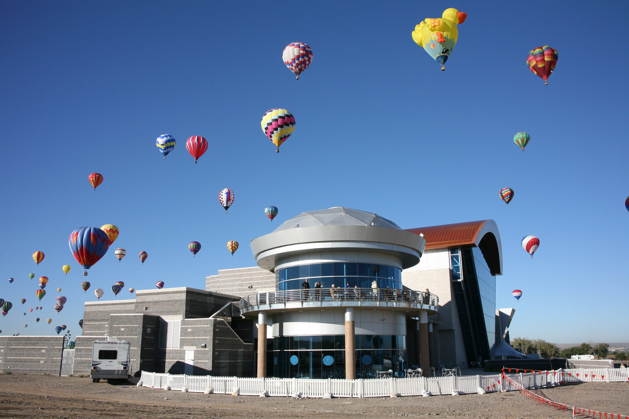 The Anderson Abruzzo Albuquerque International Balloon Museum with balloons overhead