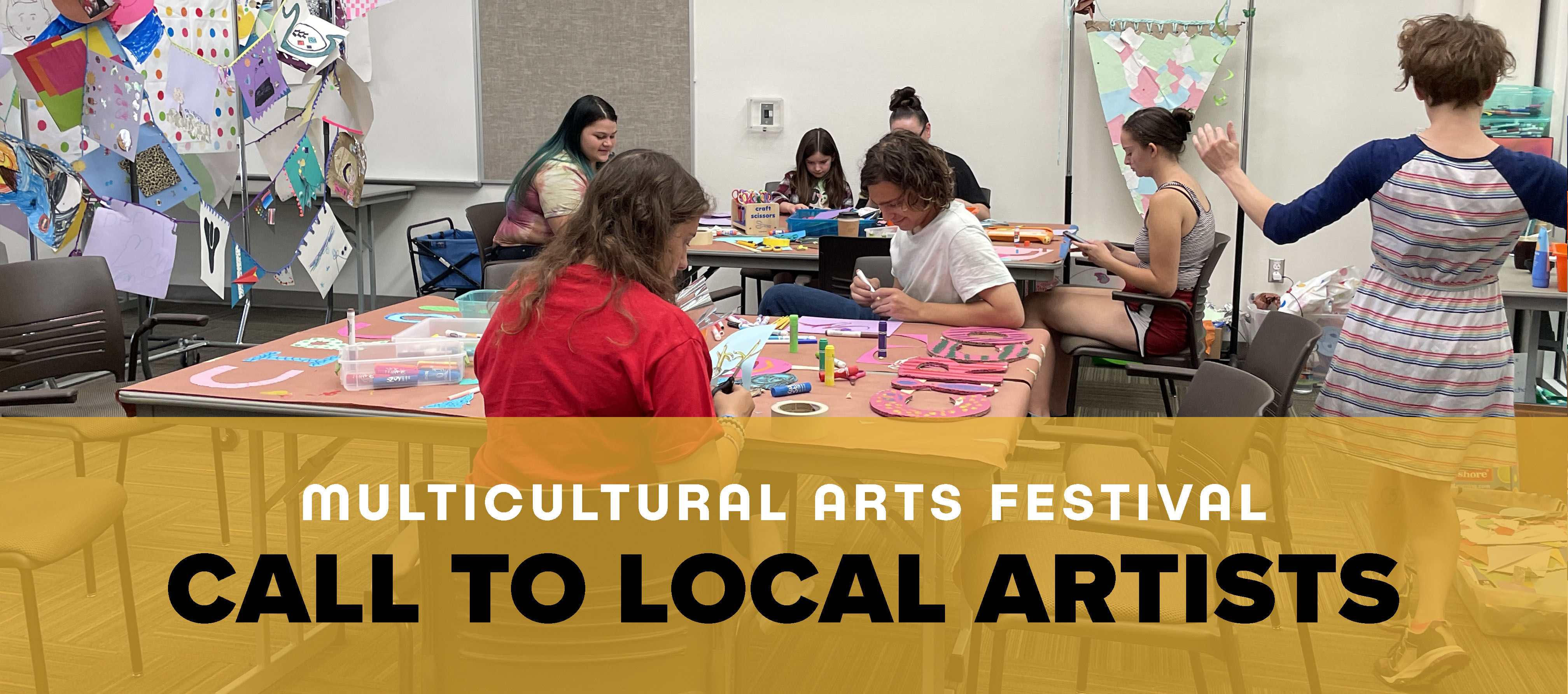 A group of teenagers in an arts and crafts room at the Singing Arrow Community center work on colored paper and cardboard art projects.