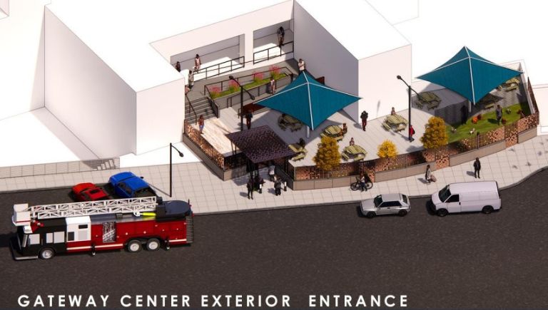 An aerial view rendering of the entrance to a building with stairs and a ramp, shade canopies, picnic tables, a grass area with dogs, people using everything mentioned, and a variety of vehicles, including a fire engine parked in front of the building.
