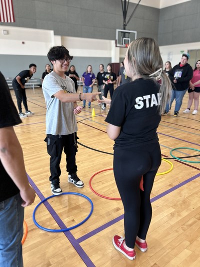 Two staff playing rock paper scissors