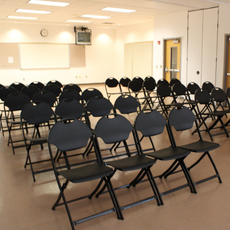 Multipurpose room with chairs set up for presentation