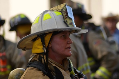 Chief Jaramillo 2026 911 Memorial Stair Climb Chief Jaramillo wearing full gear and a picture of a fallen firefighter on her helmet.