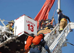 The Albuquerque Fire Department rescues four trapped balloonists on March 26, 2010, after their gondola became entangled with a light pole. The balloonists were trapped 30 feet off the ground. Photo by AFD Photographer Joseph C. Stone.