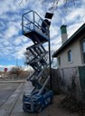 General Service worker on Cherry Picker fixing a light