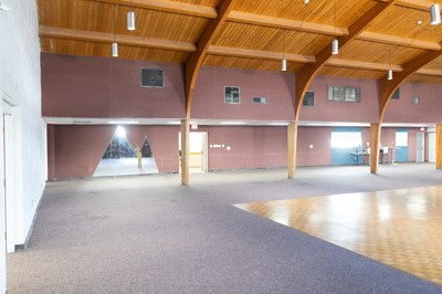 A mirror that looks mountain shaped on the wall by a dance floor.