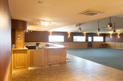 The bar from the side showing carpeted area in front of it.