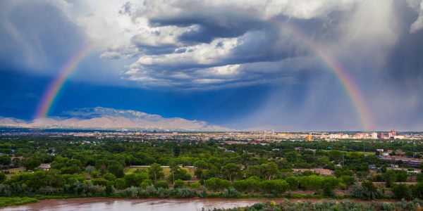 Albuquerque's horizon facing east with rainbow overhead.