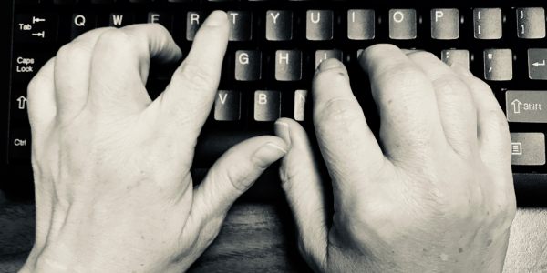 An image of hands on a keyboard.