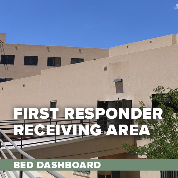 An exterior view of the Gateway Center, a beige adobe building, featuring the ramp that leads up to the First Responder Receiving Area. Text overlay: First Responder Receiving Area Bed Dashboard.