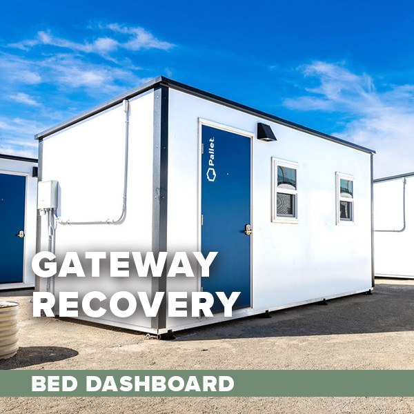 A group of small white housing unit with a blue door. Text overlay: Gateway Recovery Bed Dashboard.