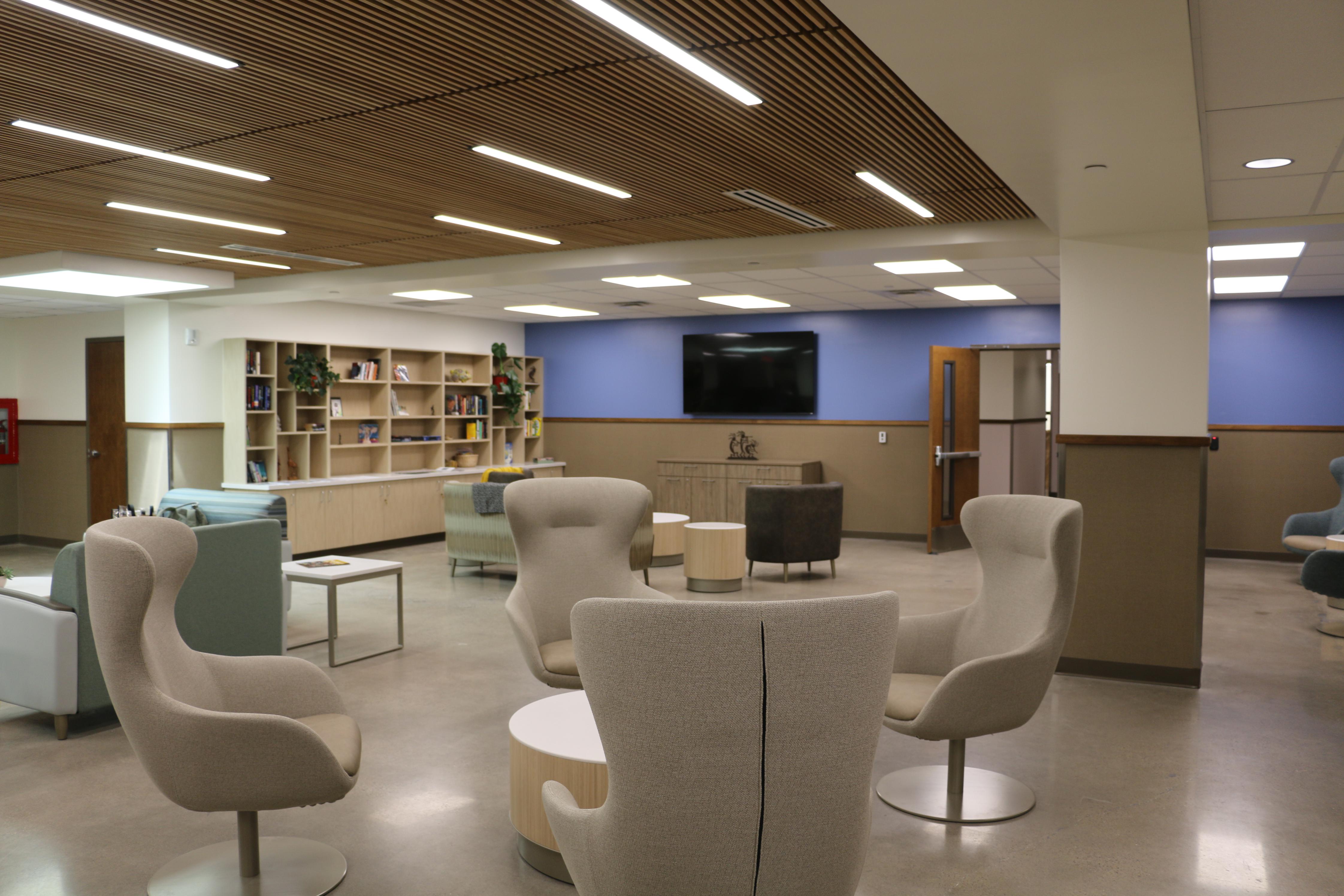 The common room of the Gateway Center with multiple seating areas and a television