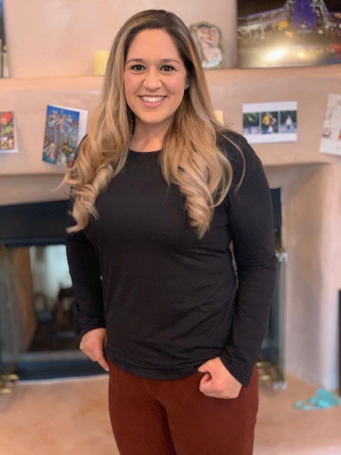 Ashley Aceves in a long sleaved black shirt and maroon pants.