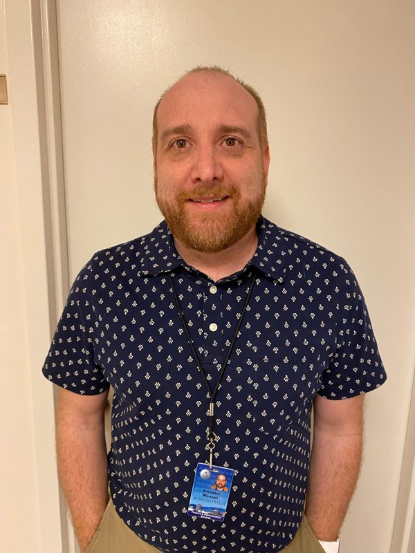 Kristopher Wessel in a blue shirt with white dots.