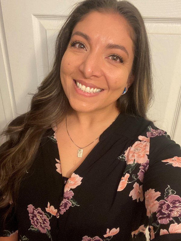 Nadia Joseph wearing a black shirt with pink flowers.