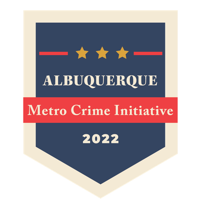 The 2022 Metro Crime Initiative (MCI) logo, featuring dark blue badge shape, a red rectangle, and the text Albuquerque Metro Crime Initiative 2022.