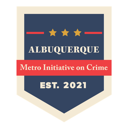 The Metro Crime Initiative (MCI) logo, featuring dark blue badge shape, a red rectangle, and the text Albuquerque Metro Crime Initiative, EST. 2021.