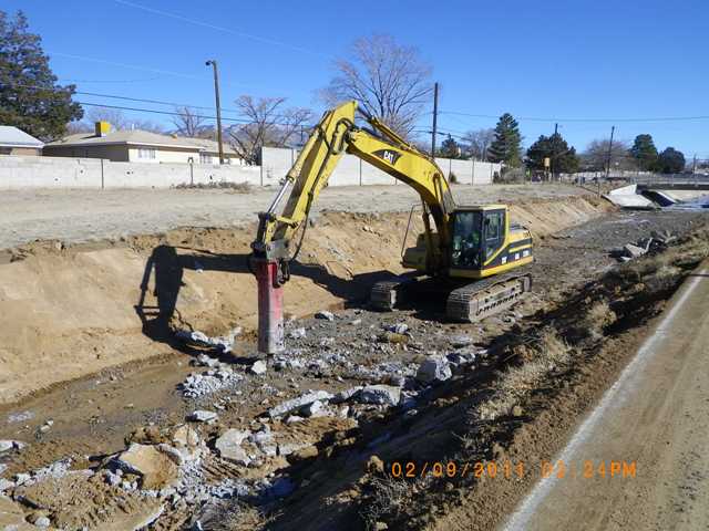 Removing concrete lining west of California bridge