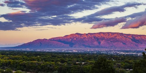 City of Albuquerque from above with the Sandia Mountains in the background at sunset