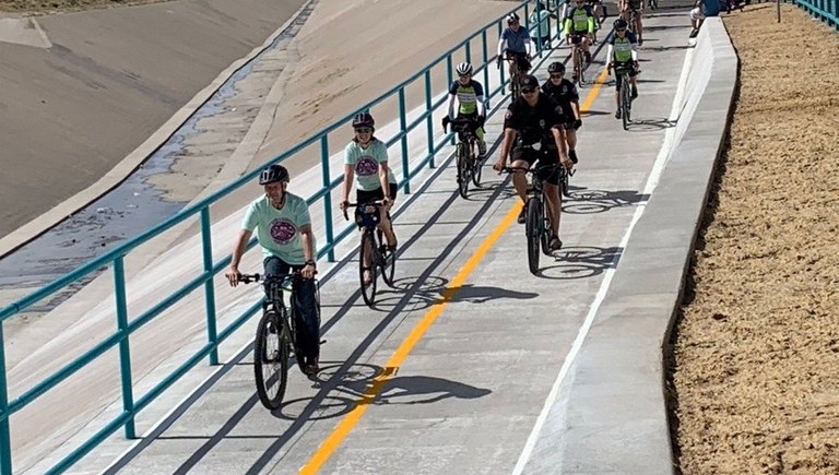 Mayor Tim Keller rides his bicycle with residents to celebrate the new Indian School Bike Notch