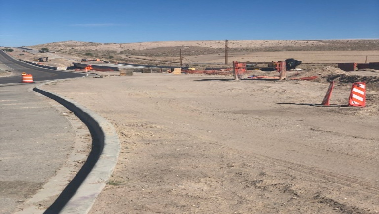 Construction crews work on the bring to Mesa Del Sol and widen the roadway.