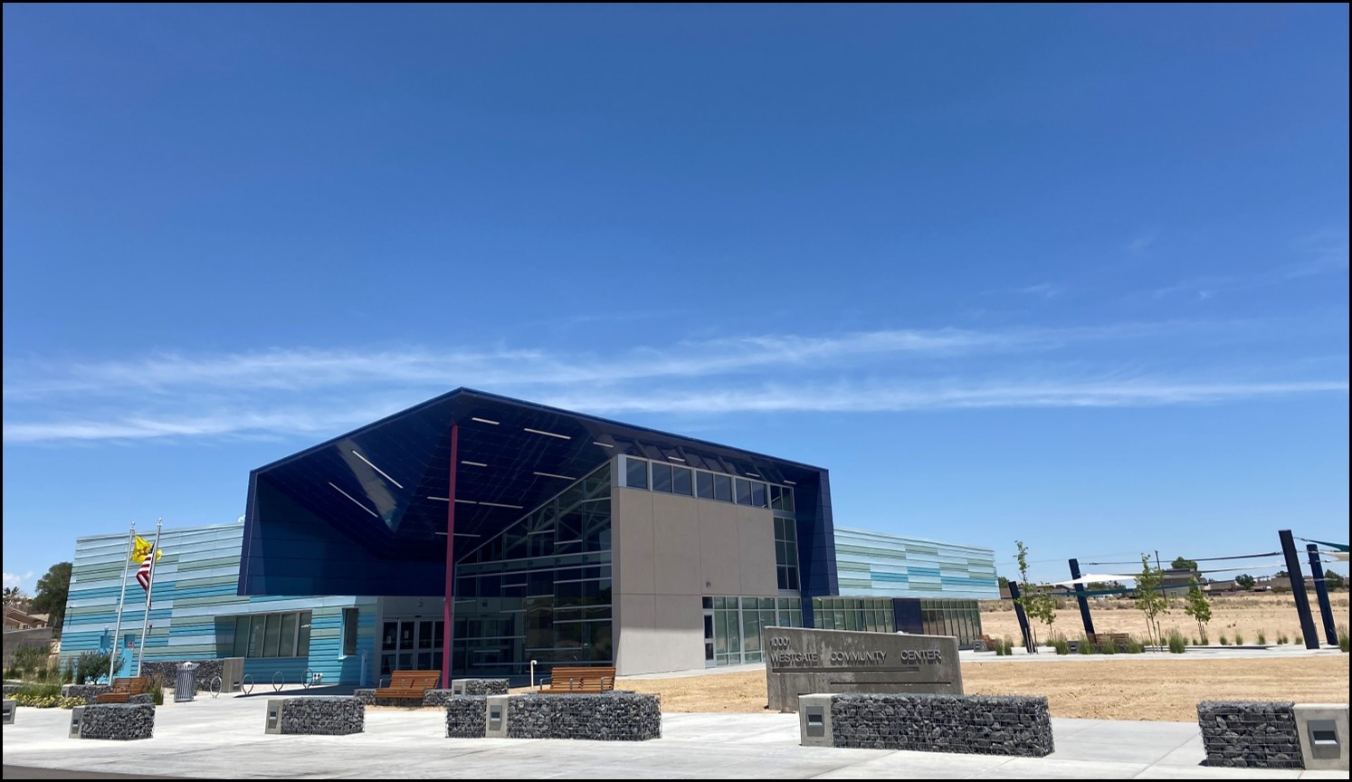 A photo of a stucco building with a blue sky behind it.