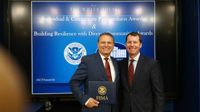 The Albuquerque Office of Emergency Management Director Ebner receiving a FEMA ‘Building Resilience with Diverse Communities’ award at the White House
