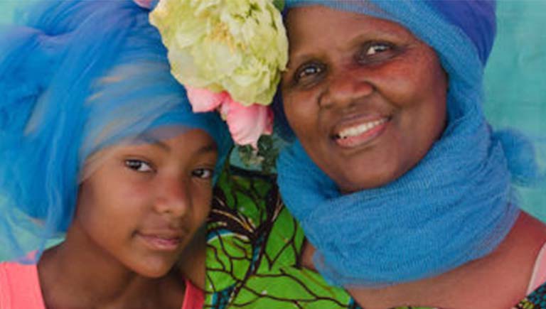 Two women of color embracing