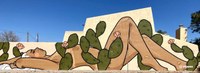 Painted wall mural of a woman reclining with cactus in the foreground and background.