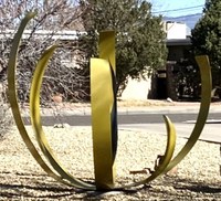 A spherical metal artwork sculpture featuring segments of curved metal suggesting the shape of a sphere in negative space.