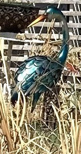 A realistic metal artwork sculpture of a crane.