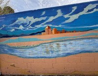 An artwork mural of Albuquerque as seen from a distance with the Rio Grande in the foreground.