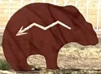 A metal bear sculpture in the cut-out style, in profile, with the Heartline arrow pointing from the mouth to the rear.