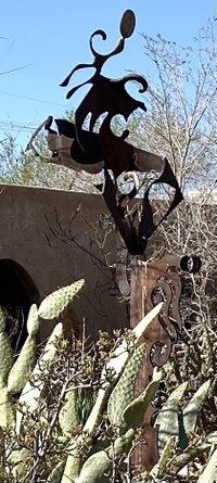 A metal artwork sculpture of of flowing, undefined shapes.