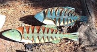A metal sculpture of two fish.