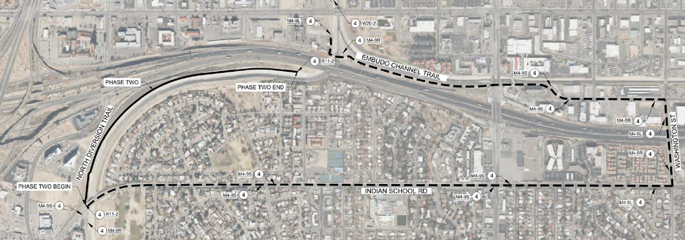 NDC Detour Map - Phase 1 An aerial map showing a dotted line going east on the Embud Channel trail to Washington St., south on Washington St. to Indian School Rd., then west on Indian School Rd to the North Diversion Trail. A solid line labled Phase two goes north on the diversion trail until it ends right before the main road.