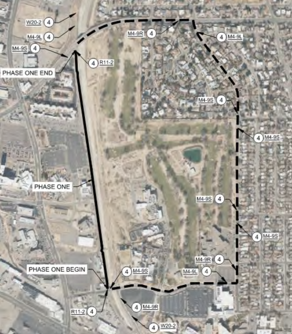 NDC Detour Map - Phase 2 An aerial map with a dotted line going around a large field that has a residential area on the northeast side. There is a solid black line on the west side labled Phase one. No streets are labeled.