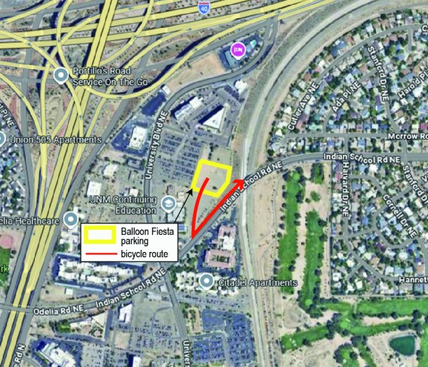 An aerial map showing a bicycle parking area for the Balloon Fiesta in the lot northwest of Indian School and Unibersity. The route to leave is south from the lot to Indian School, then north on Indian School.