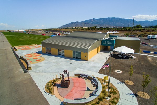 Sid Cutter Aerial View An aerial view of Sid Cutter Pilot's Pavilion with a statue of a balloon basket in the front and a grass field on the side.
