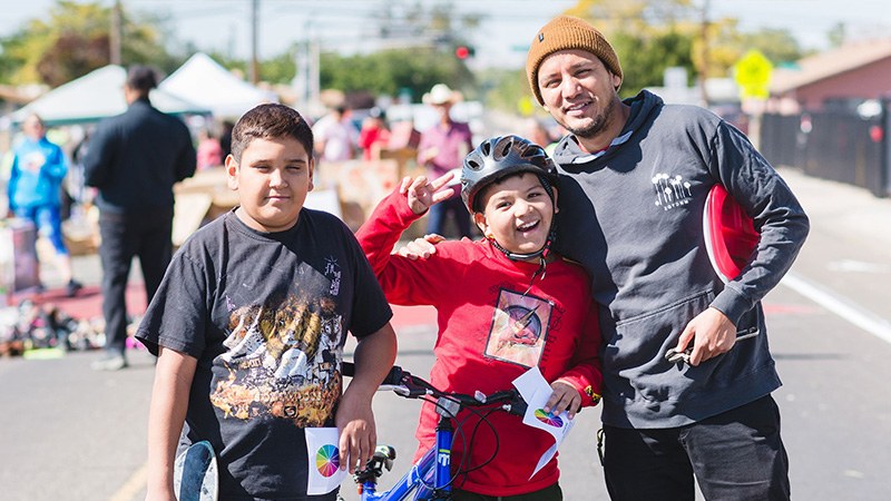 A family smiles with bikes