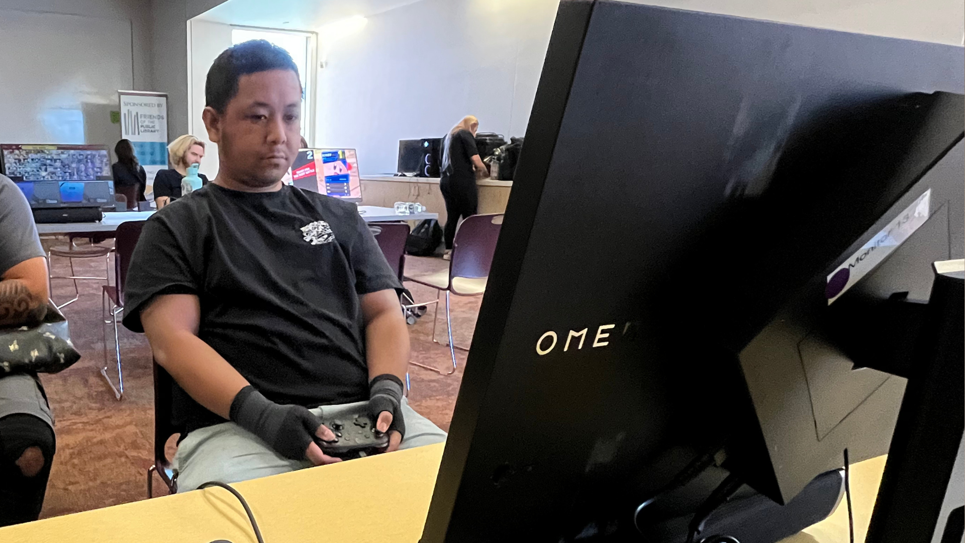 A young man with blonde hair and a red and white esports jersey