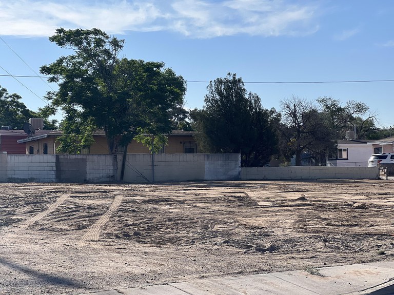 A clear residential lot after the dilapidated structure was demolished.