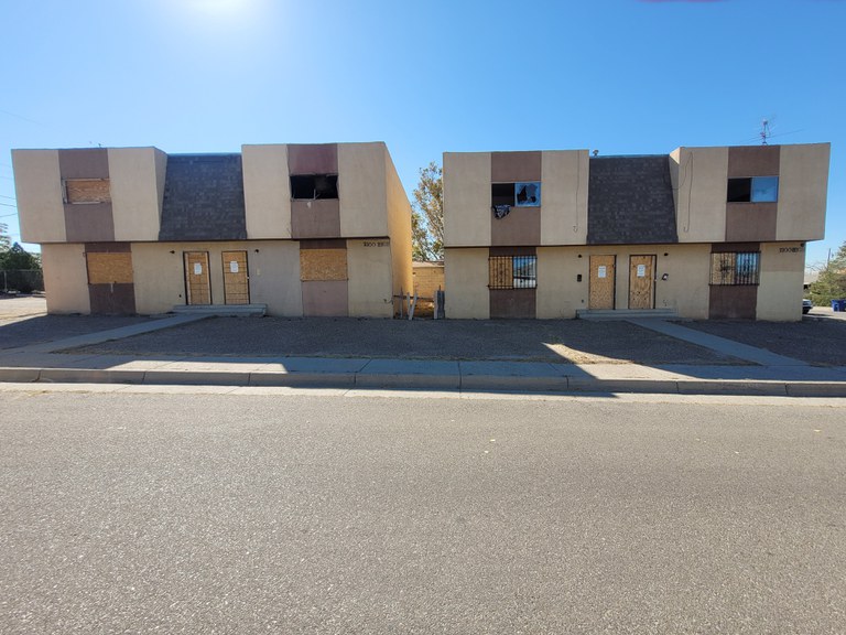 Two dilapidated townhomes in need of repair.