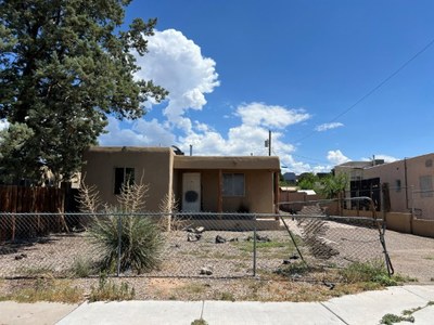 A dilapidated adobe house in need of repair.