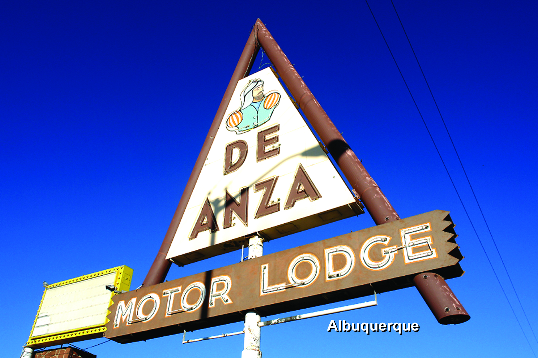 Photo showing the neon sign for the De Anza Motor Lodge. 