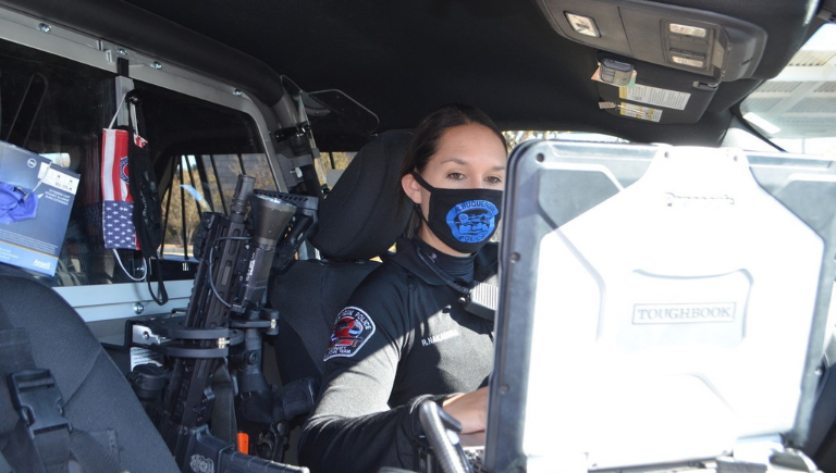 Female officer in her unit on her laptop