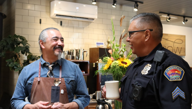 Officer at coffee with a cop event talking to community member