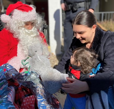 picture of Santa giving a child a gift during the Benny Hargrove Giving Tree event