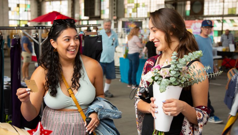 Two women shopping at the Rail Yards Market.