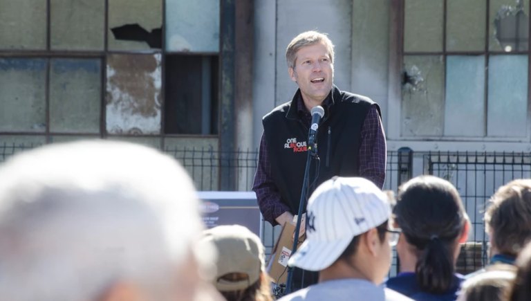 Mayor Keller giving a speech to a crowd in front of the Rail Yards.