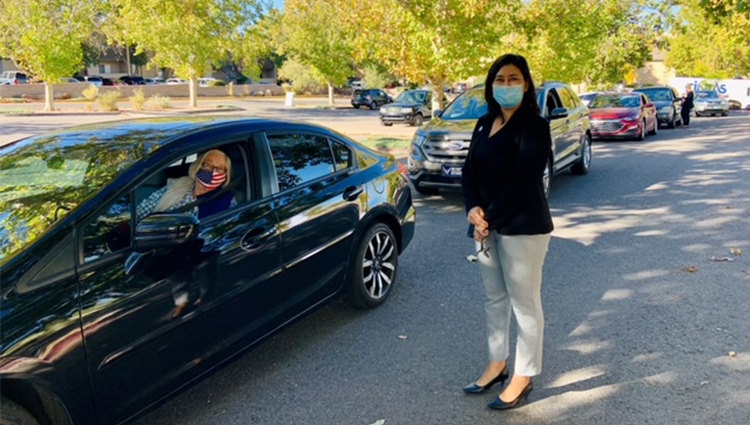 Senior Woman in Car with Senior Affairs Staff Member Standing Outside